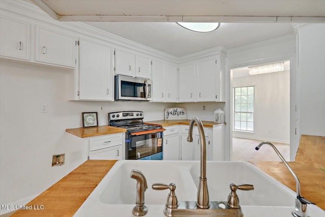 602 Hathaway Dr, Clinton, MS 39056 - kitchen with appliances with stainless steel finishes, white cabinetry, and wooden counters