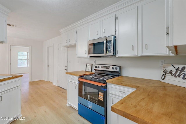 602 Hathaway Dr, Clinton, MS 39056 - kitchen featuring stainless steel appliances, butcher block counters, light wood-type flooring, and white cabinets