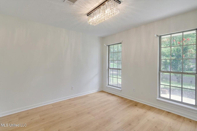 602 Hathaway Dr, Clinton, MS 39056 - spare room with light wood-style floors and a chandelier