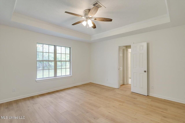 602 Hathaway Dr, Clinton, MS 39056 - unfurnished room featuring a tray ceiling, ornamental molding, a ceiling fan, and light wood-style flooring