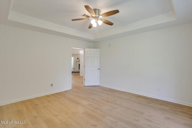 602 Hathaway Dr, Clinton, MS 39056 - empty room featuring a tray ceiling, ornamental molding, ceiling fan, and light wood-type flooring