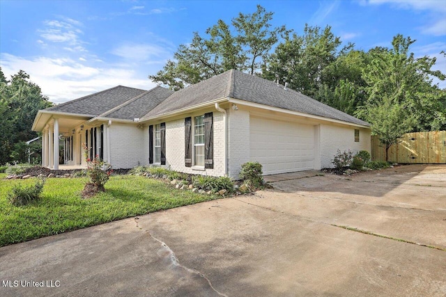 602 Hathaway Dr, Clinton, MS 39056 - view of property exterior with brick siding, driveway, a garage, and a shingled roof