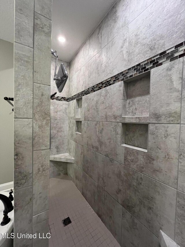 full bathroom with a tile shower