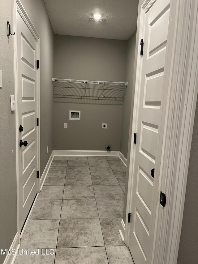 laundry room with laundry area, baseboards, hookup for a washing machine, hookup for an electric dryer, and a textured ceiling