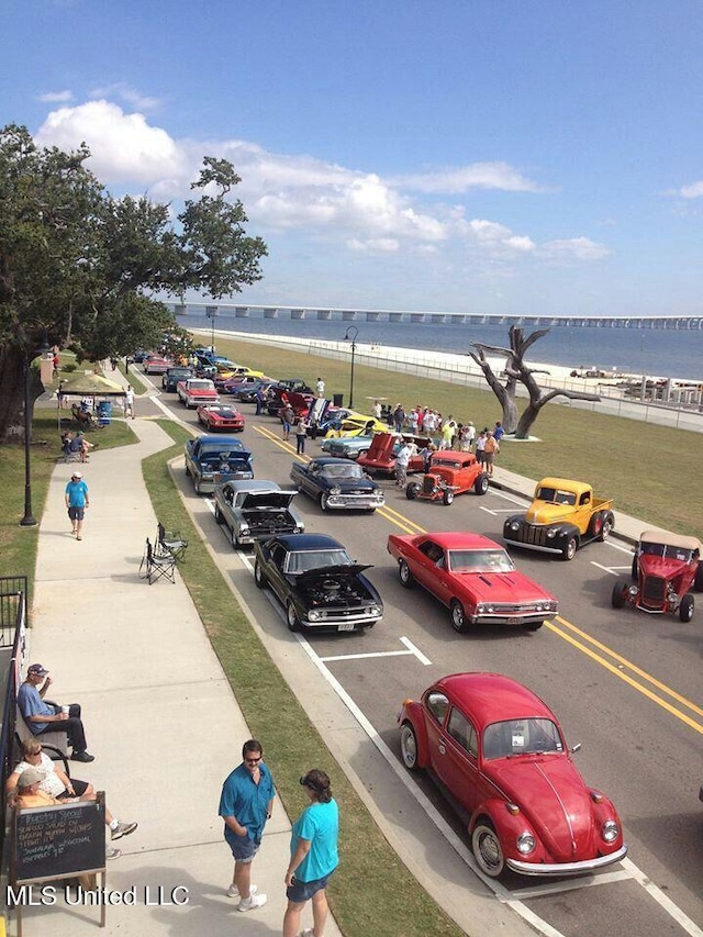 uncovered parking lot featuring a water view