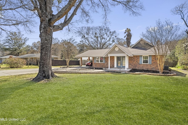 view of front of home with a carport, fence, brick siding, and a front lawn