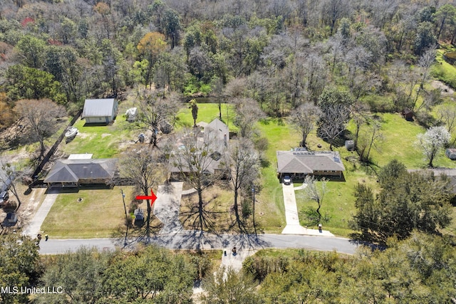 drone / aerial view featuring a view of trees