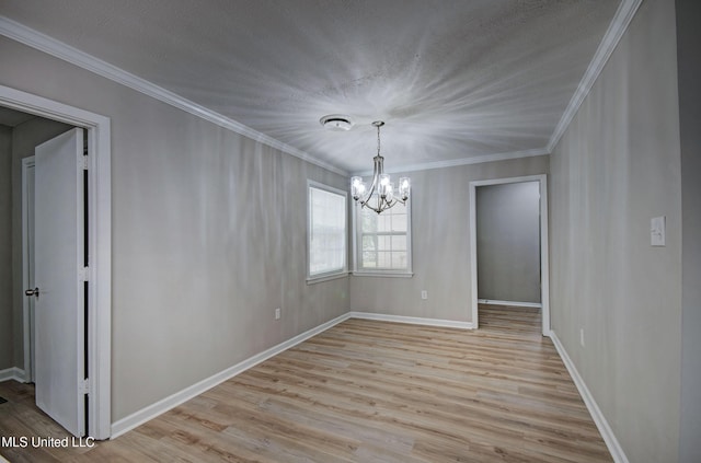 1201 Manchester Dr, Clinton, MS 39056 - unfurnished dining area featuring ornamental molding, light wood-style flooring, and a notable chandelier