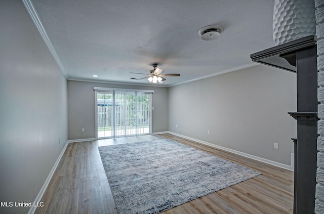 1201 Manchester Dr, Clinton, MS 39056 - unfurnished living room with ornamental molding, wood finished floors, a fireplace, baseboards, and ceiling fan