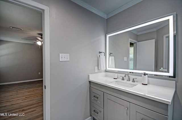 1201 Manchester Dr, Clinton, MS 39056 - bathroom with vanity, a ceiling fan, baseboards, wood finished floors, and ornamental molding