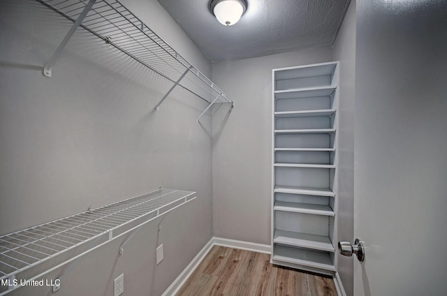 1201 Manchester Dr, Clinton, MS 39056 - walk in closet featuring wood finished floors