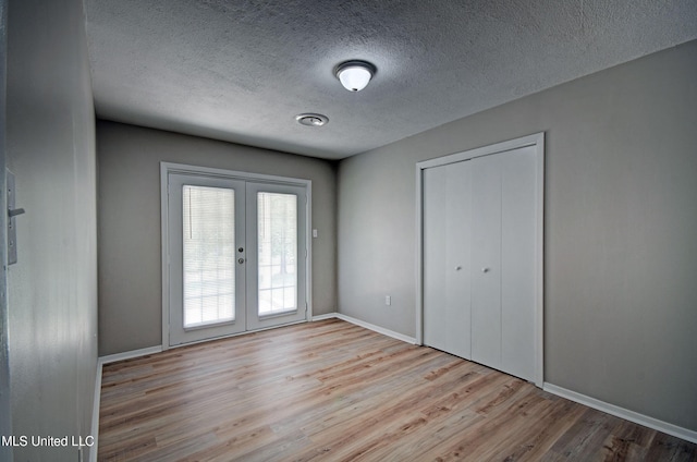 1201 Manchester Dr, Clinton, MS 39056 - interior space with a closet, wood finished floors, baseboards, a textured ceiling, and french doors