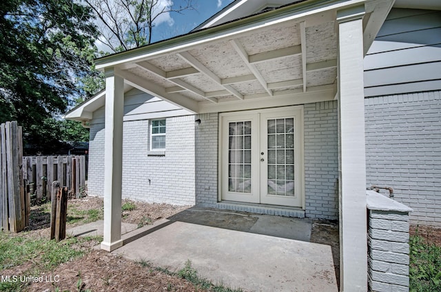 1201 Manchester Dr, Clinton, MS 39056 - doorway to property with brick siding, a patio area, fence, and french doors