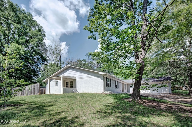 1201 Manchester Dr, Clinton, MS 39056 - view of side of property with a lawn, fence, and brick siding