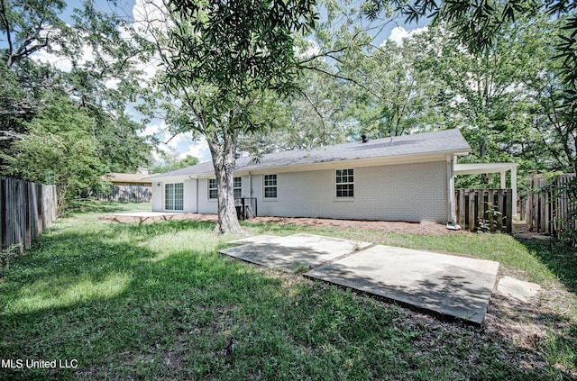 1201 Manchester Dr, Clinton, MS 39056 - back of property with a lawn, a fenced backyard, a patio area, and brick siding