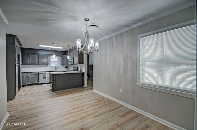 1201 Manchester Dr, Clinton, MS 39056 - kitchen featuring baseboards, a chandelier, tasteful backsplash, light wood finished floors, and appliances with stainless steel finishes