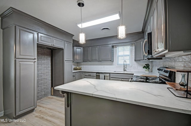 1201 Manchester Dr, Clinton, MS 39056 - kitchen with gray cabinetry, appliances with stainless steel finishes, backsplash, and light stone counters
