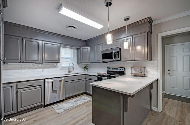 1201 Manchester Dr, Clinton, MS 39056 - kitchen featuring gray cabinets, appliances with stainless steel finishes, a sink, a peninsula, and ornamental molding