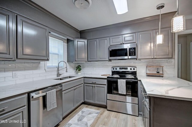 1201 Manchester Dr, Clinton, MS 39056 - kitchen featuring ornamental molding, light wood-type flooring, gray cabinets, a sink, and appliances with stainless steel finishes