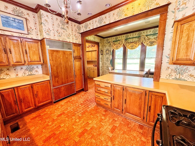 5010 Old Hwy 49, Clarksdale, MS 38614 - kitchen with wallpapered walls, paneled built in refrigerator, black gas stove, ornamental molding, and a chandelier