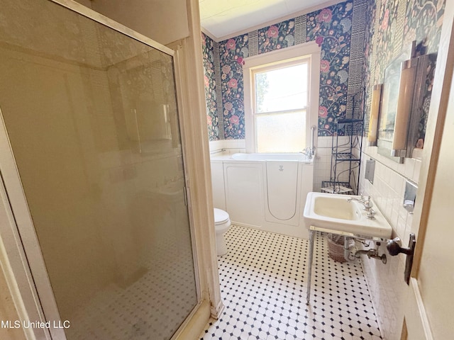 5010 Old Hwy 49, Clarksdale, MS 38614 - bathroom featuring wallpapered walls, toilet, a shower stall, a wainscoted wall, and a bath