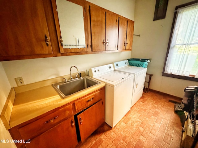 5010 Old Hwy 49, Clarksdale, MS 38614 - washroom featuring cabinet space, separate washer and dryer, brick patterned floors, and plenty of natural light