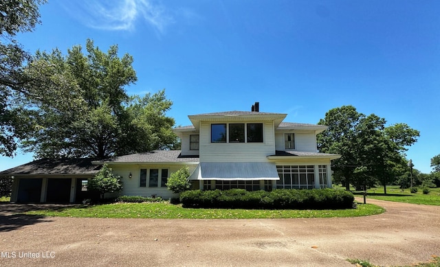 5010 Old Hwy 49, Clarksdale, MS 38614 - view of front of home with driveway, a garage, a sunroom, and a chimney