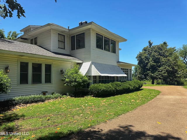 5010 Old Hwy 49, Clarksdale, MS 38614 - view of side of property featuring roof with shingles, a yard, and a chimney