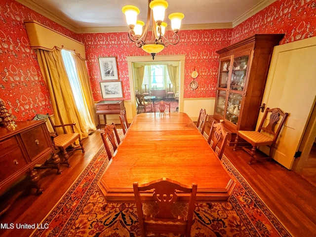 5010 Old Hwy 49, Clarksdale, MS 38614 - dining room featuring wallpapered walls, wood finished floors, a chandelier, crown molding, and wainscoting