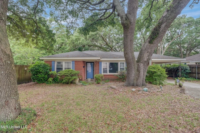 277 Rodenberg Ave, Biloxi, MS 39531 - ranch-style home featuring brick siding, fence, a carport, and driveway