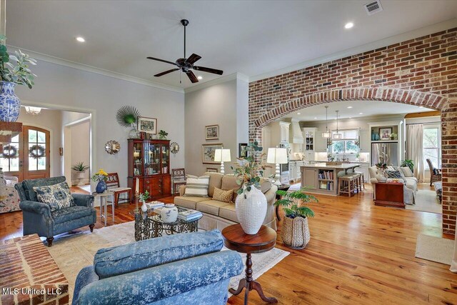 181 Ironwood Plantation Blvd, Madison, MS 39110 - living room featuring arched walkways, light wood-style flooring, a ceiling fan, ornamental molding, and recessed lighting