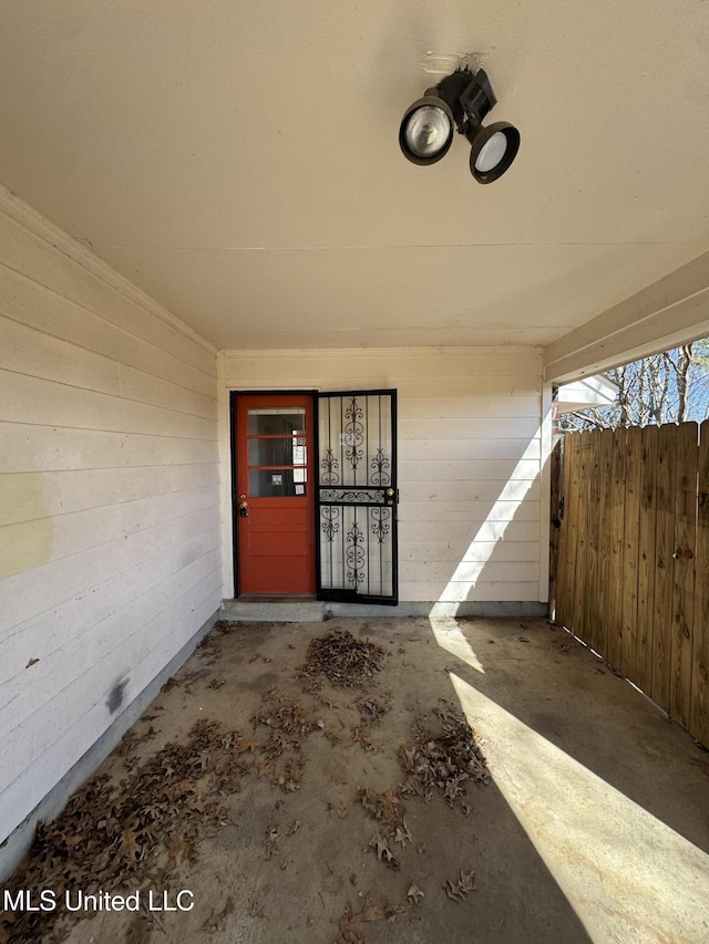 view of exterior entry with fence