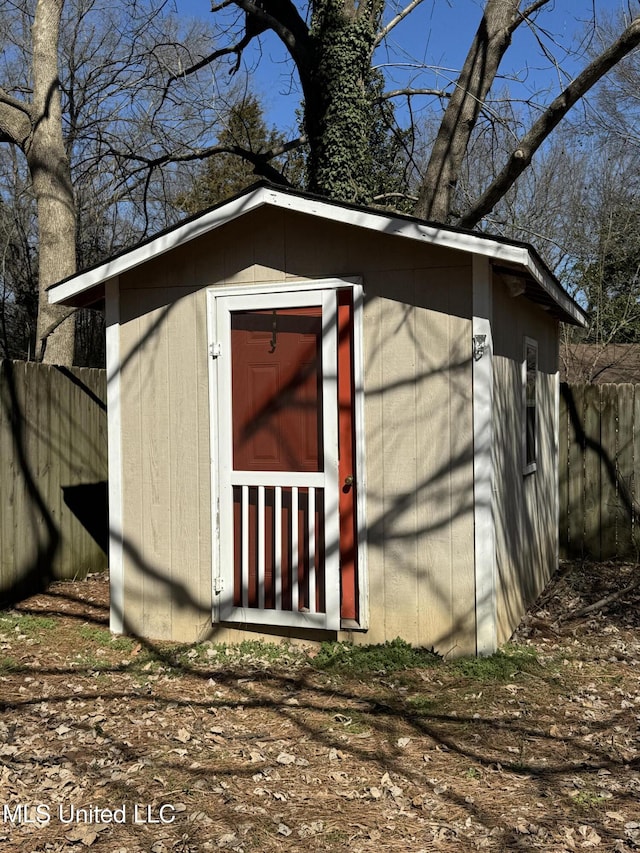 view of shed featuring fence