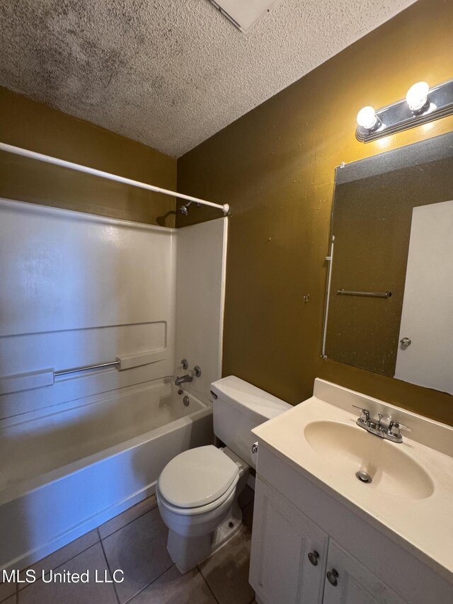 bathroom featuring a textured ceiling, tile patterned flooring, toilet, shower / bath combination, and vanity