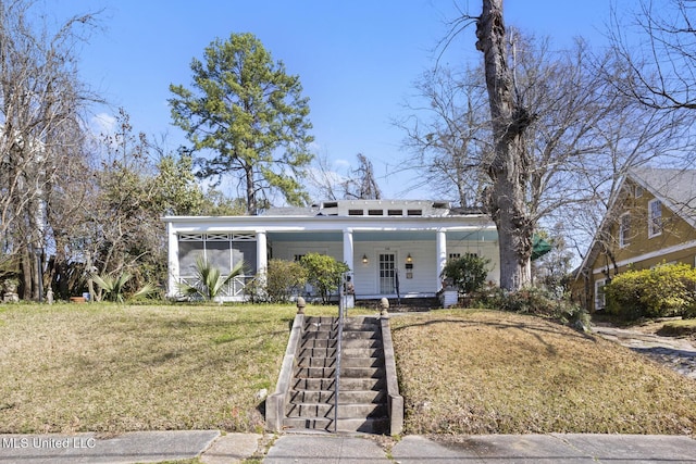 view of front of home featuring covered porch, a front lawn, and a sunroom