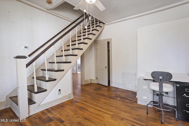 stairs featuring hardwood / wood-style floors