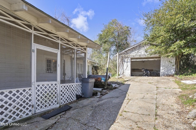 view of property exterior featuring a detached garage and an outdoor structure