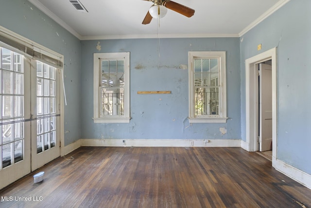 spare room featuring hardwood / wood-style floors, crown molding, visible vents, and a wealth of natural light