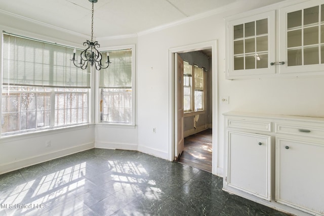 unfurnished dining area with an inviting chandelier, baseboards, a wealth of natural light, and ornamental molding