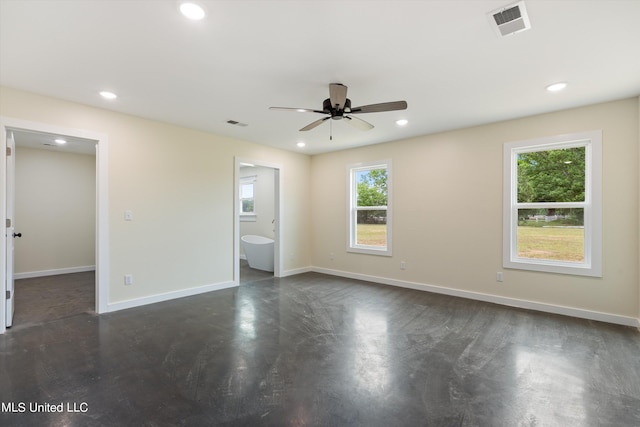 unfurnished bedroom featuring a spacious closet, ensuite bathroom, and ceiling fan