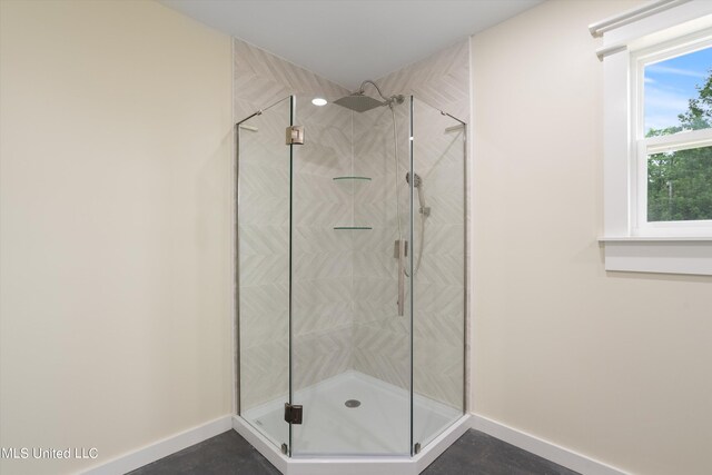 bathroom with a shower with shower door