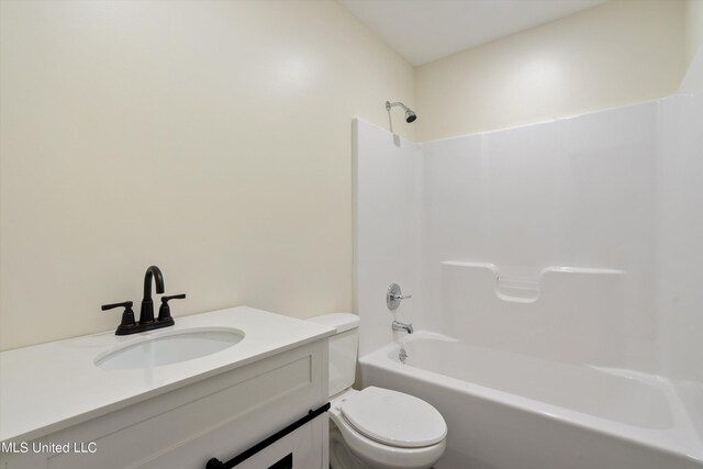 full bathroom with vanity, washtub / shower combination, and toilet