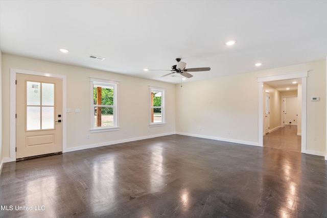 unfurnished living room with dark wood-type flooring and ceiling fan