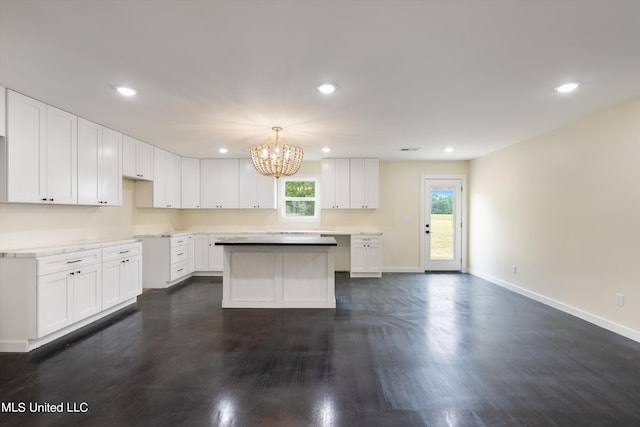 kitchen featuring white cabinets, decorative light fixtures, and plenty of natural light