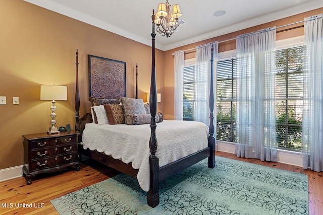 bedroom with hardwood / wood-style flooring and multiple windows