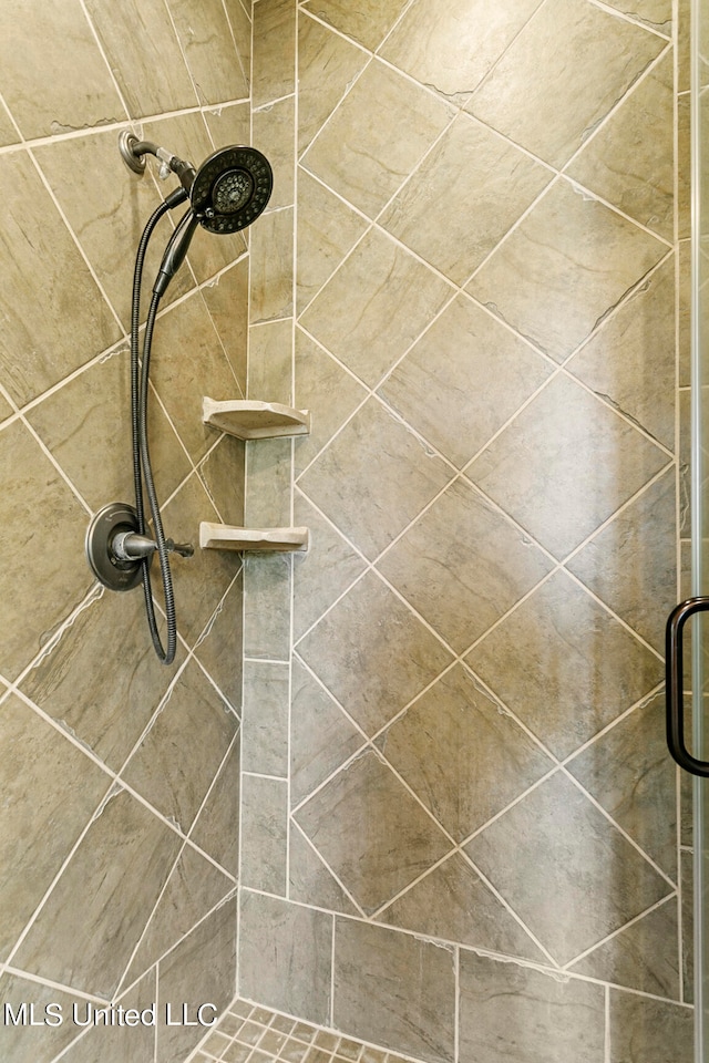 bathroom featuring a shower with door