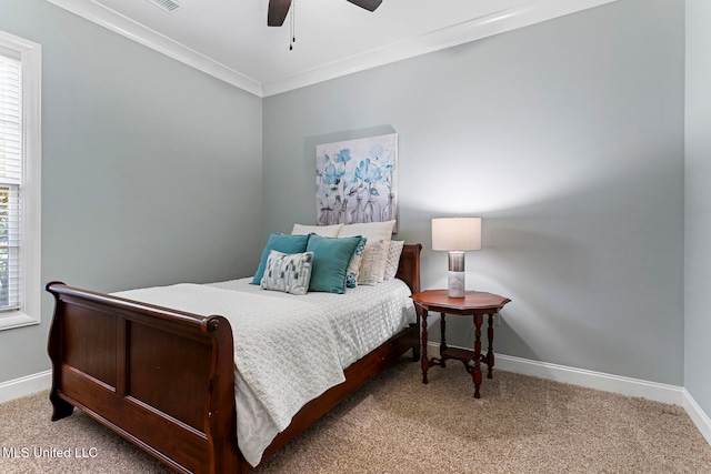 bedroom with ceiling fan, carpet, and ornamental molding