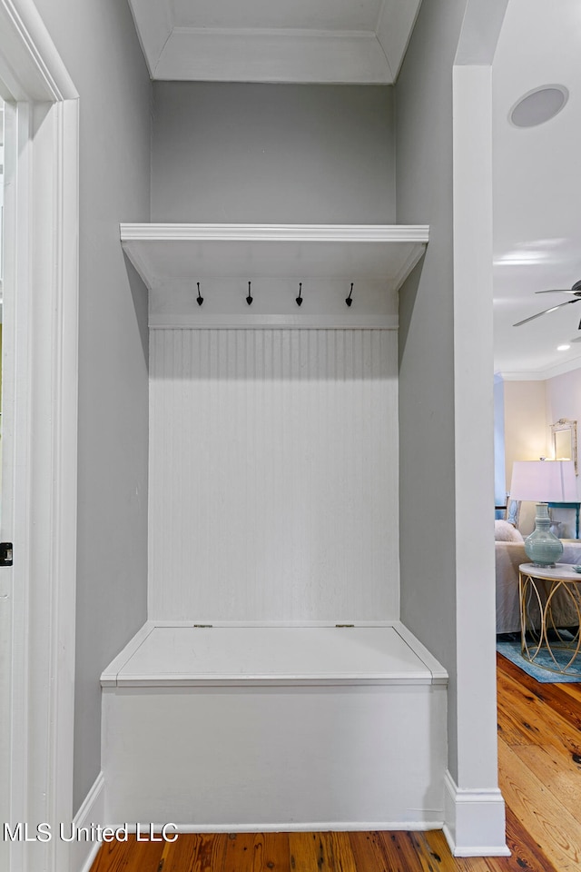 mudroom with ornamental molding, hardwood / wood-style flooring, and ceiling fan