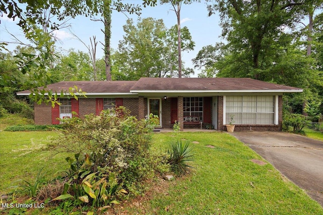 2530 Crestleigh Mnr, Jackson, MS 39204 - ranch-style house featuring a front yard, concrete driveway, brick siding, an attached garage, and a porch