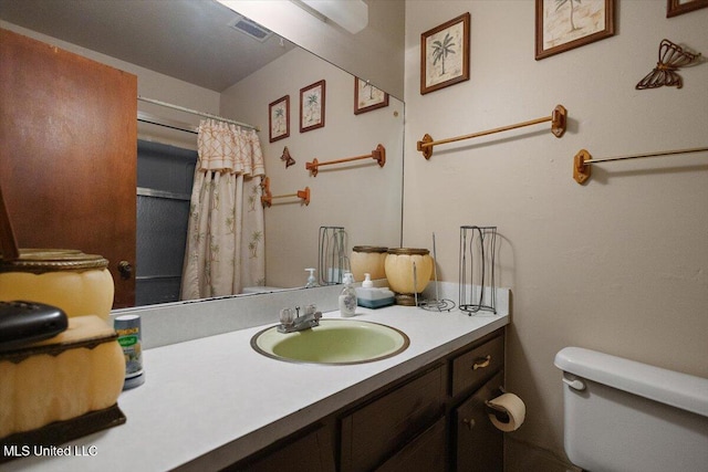 2530 Crestleigh Mnr, Jackson, MS 39204 - bathroom featuring toilet, vanity, and curtained shower
